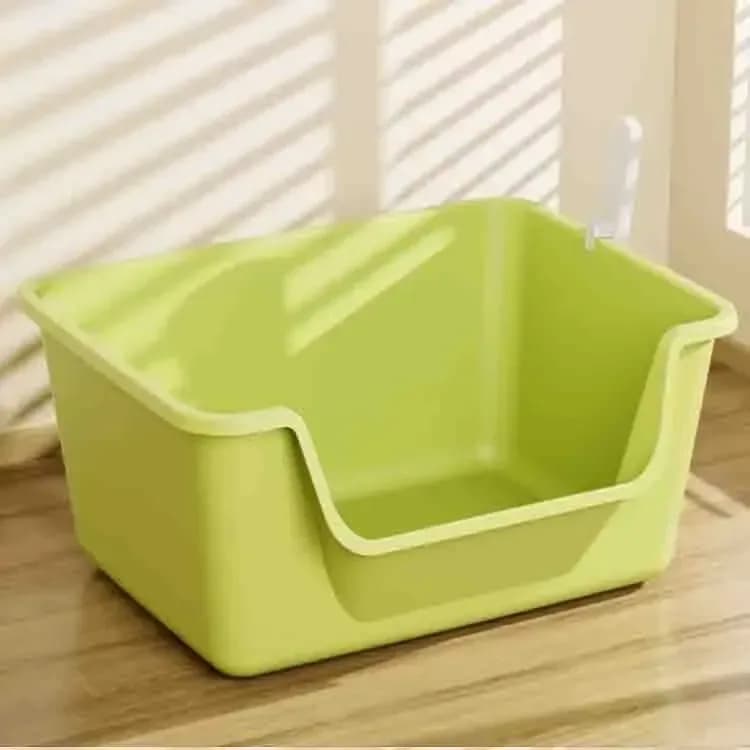 green high sided open cat litter box in a living room