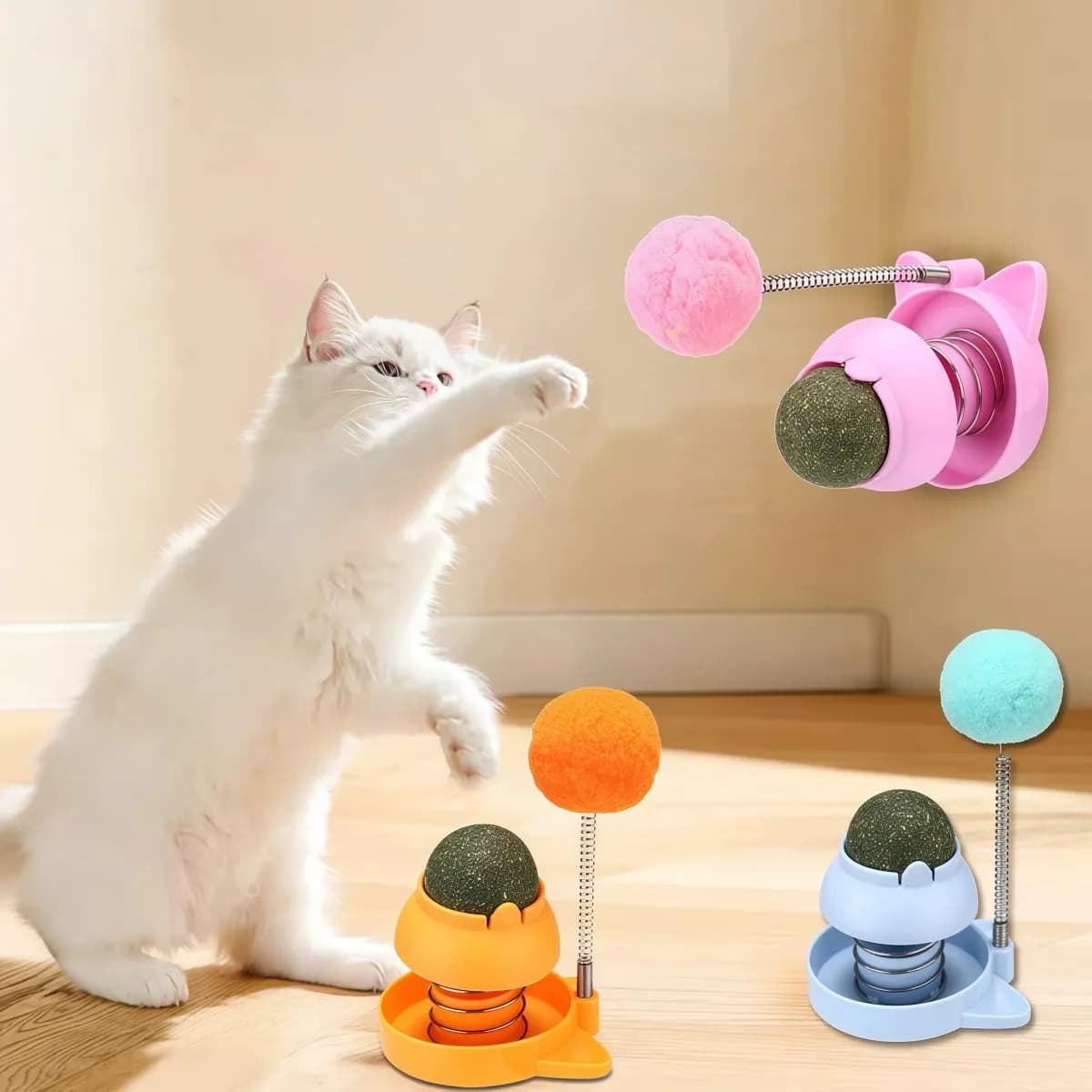 kitten batting a wall mount catnip ball cat toy with spring pom-pom